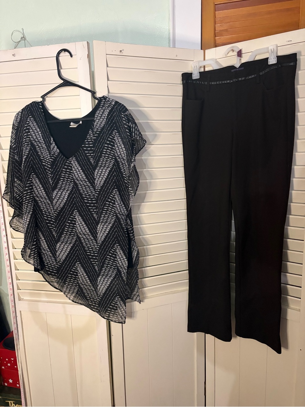 This is a two piece outfit that includes NYDJ dress pants and a Cache cape top